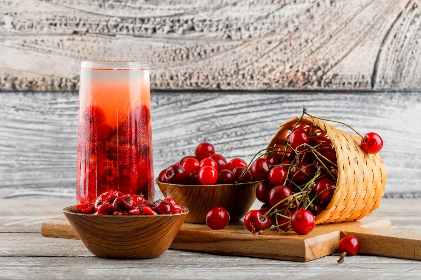 cherry drink jug with cherries jam side view wooden cutting board