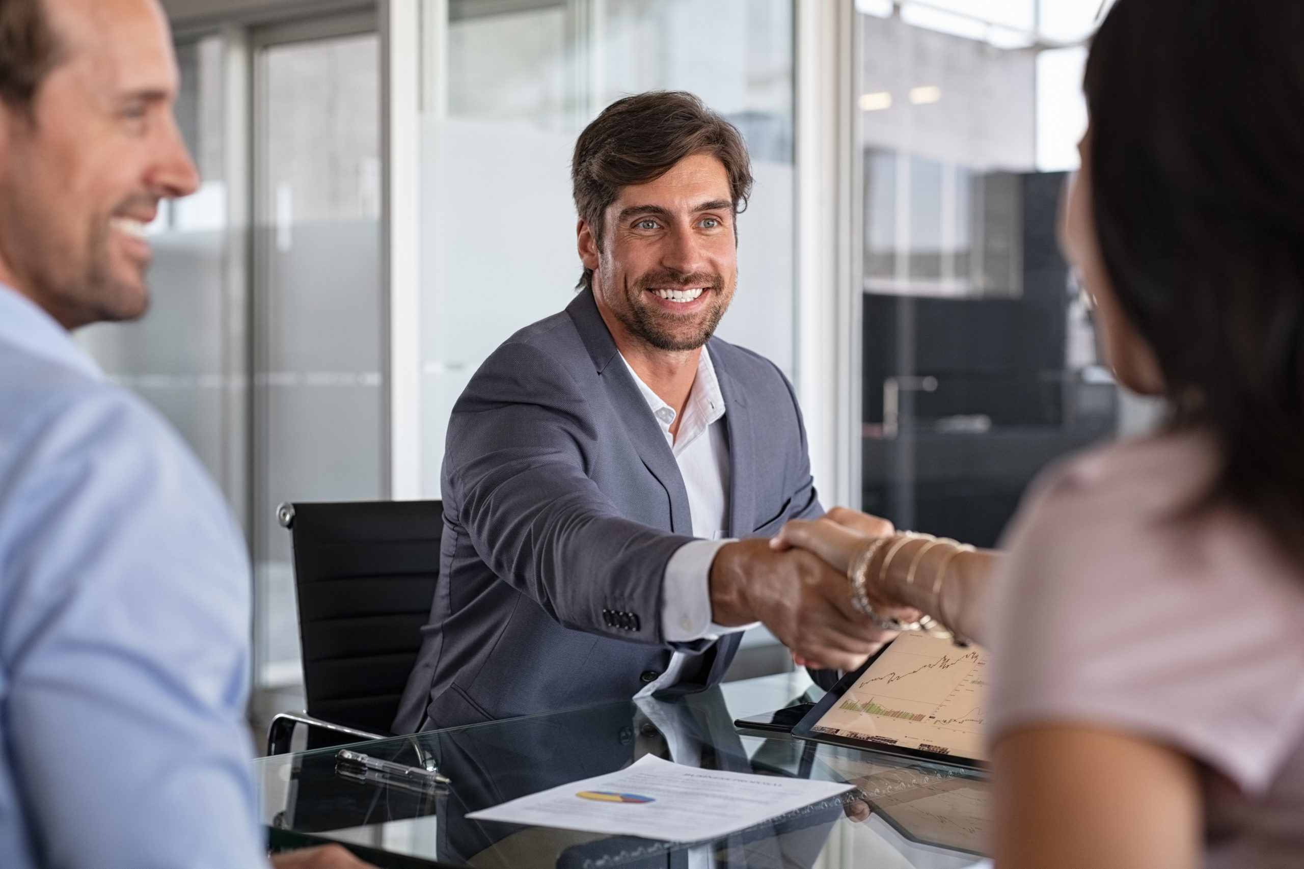 financial advisor shaking hand to seal a deal